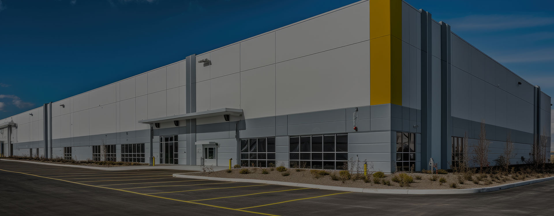 A large warehouse building with yellow accents.