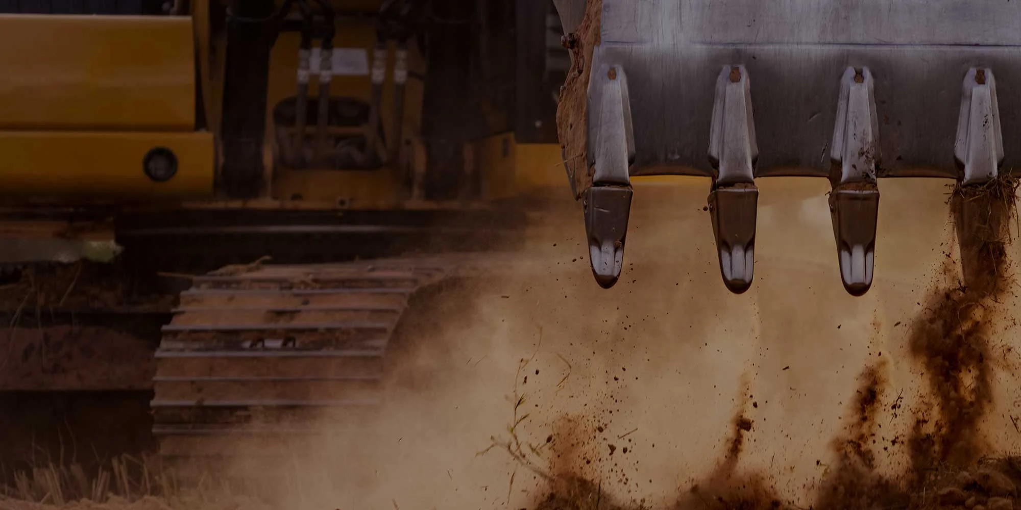 A bulldozer is digging up dirt in a field.